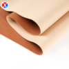 Brown textured PVC upholstery leather showing the surface and soft backing